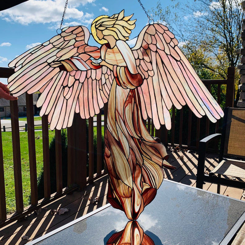 Acrylic angel-shaped suncatcher pendant hanging in a home garden window, ideal for craft decoration and scene enhancement.