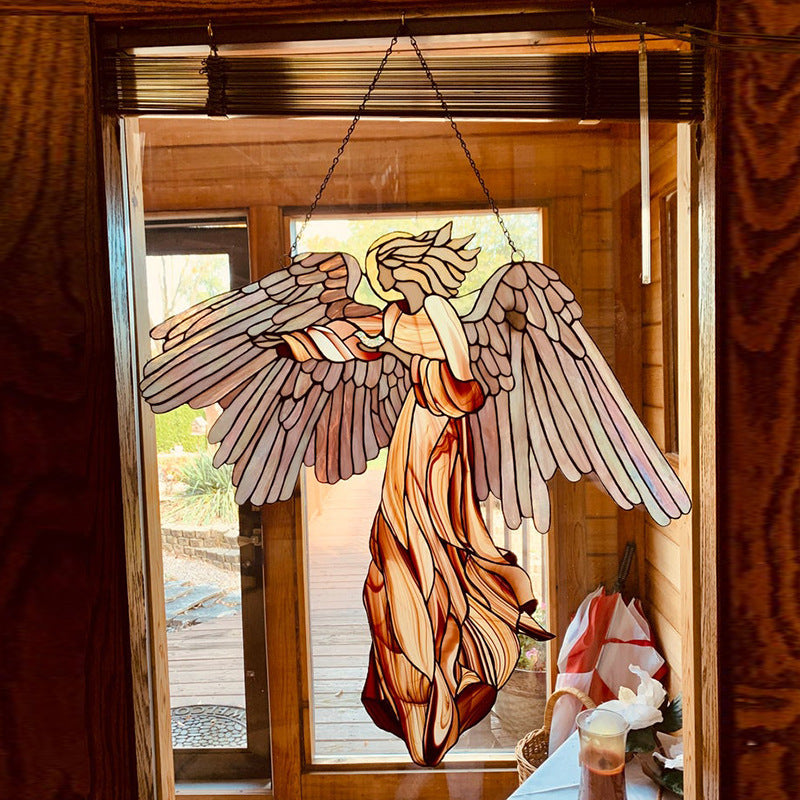 Acrylic angel-shaped suncatcher pendant hanging in a home garden window, ideal for craft decoration and scene enhancement.