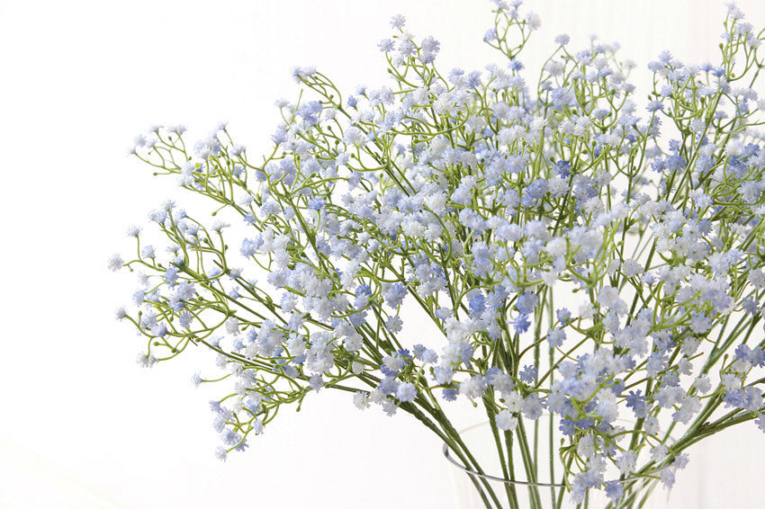 White Gypsophila artificial flowers with 90 blooms and 52cm stems arranged in a vase, ideal for home decor or wedding floral arrangements.