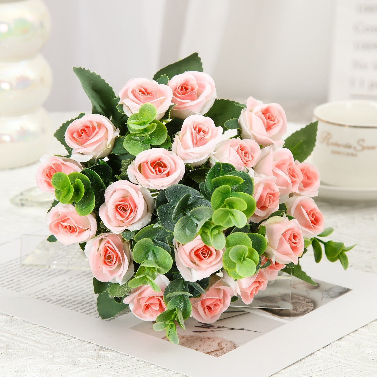 Red silk rose bouquet with green eucalyptus in crystal vase for living room decoration or wedding ceremony artificial flower arrangement.