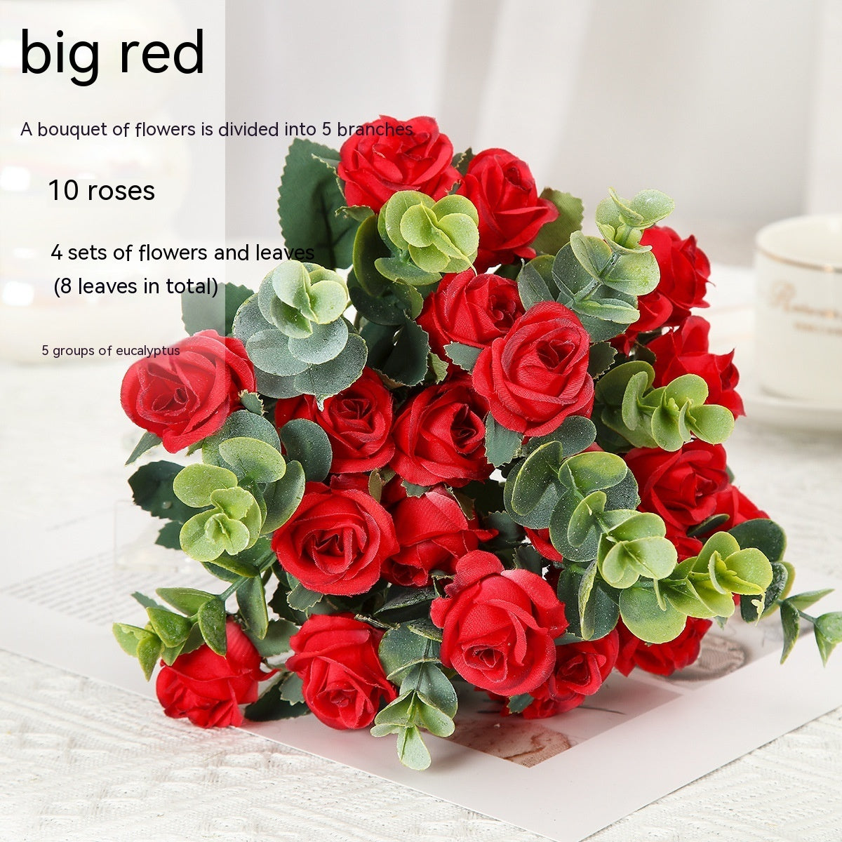 Red silk rose bouquet with green eucalyptus in crystal vase for living room decoration or wedding ceremony artificial flower arrangement.