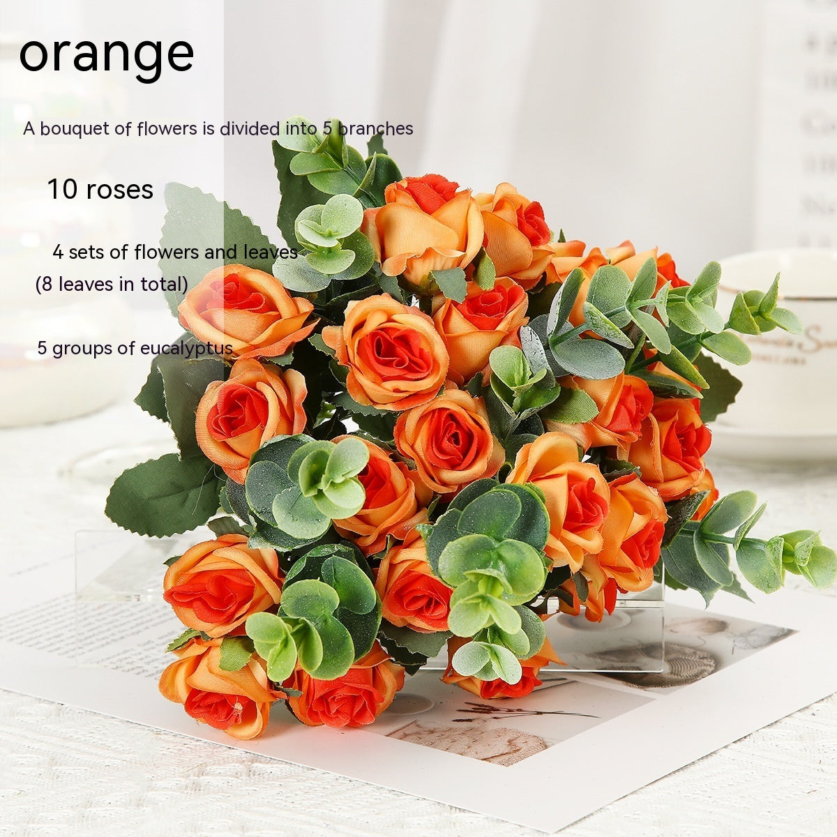 Red silk rose bouquet with green eucalyptus in crystal vase for living room decoration or wedding ceremony artificial flower arrangement.