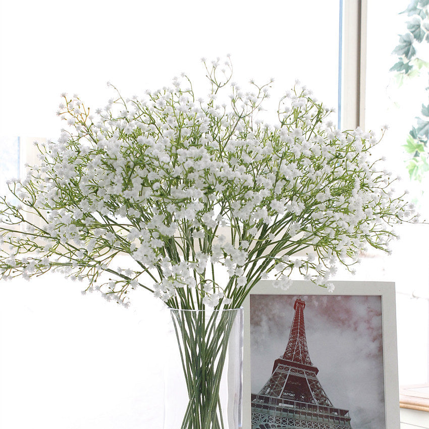 White Gypsophila artificial flowers with 90 blooms and 52cm stems arranged in a vase, ideal for home decor or wedding floral arrangements.