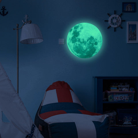 Luminous Wall Stickers Recycling Lunar Environmental Wall Stickers glowing moon decal on blue wall in kids' nautical-themed bedroom. Eco-friendly PVC design.